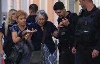 a woman and a police officer help a woman from a nearby building after an old building partially collapsed following an explosion in the plaka area which is popular with tourists in central athens greece september 25 2026 reuters