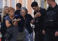 a woman and a police officer help a woman from a nearby building after an old building partially collapsed following an explosion in the plaka area which is popular with tourists in central athens greece september 25 2026 reuters