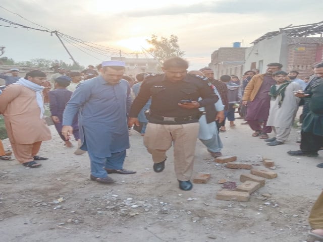 a police official inspects the blast site in peshawar photo express