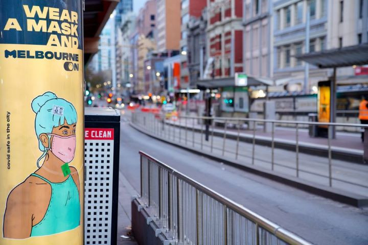 a wear a mask sign is seen on a mostly empty city street during morning commute hours on the first day of a seven day lockdown as the state of victoria looks to curb the spread of a coronavirus disease covid 19 outbreak in melbourne australia may 28 2021 reuters sandra sanders