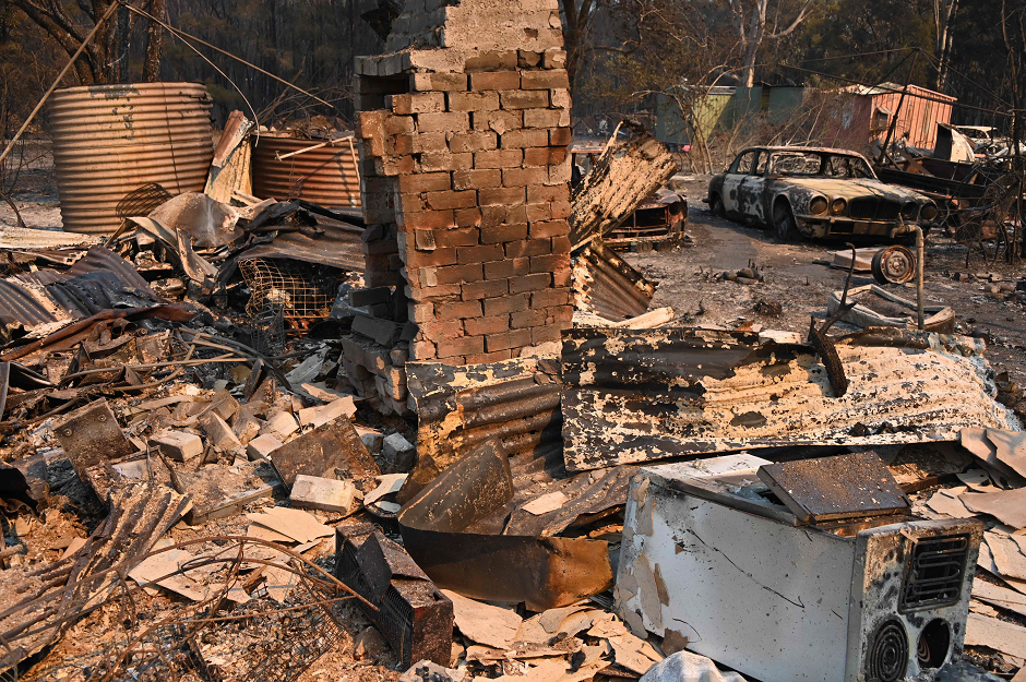 A vintage Jaguar car sits in ruins after a bushfire destroyed a property in Old Bar, 350km north of Sydney on November 10, 2019. PHOTO: AFP