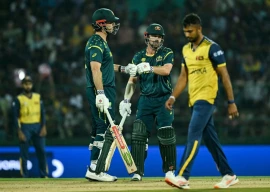 australia s captain mitchell marsh l and travis head c bump their fists during the 2026 icc men s t20 cricket world cup group stage match between australia and sri lanka at pallekele international cricket stadium in kandy on february 16 2026 photo afp