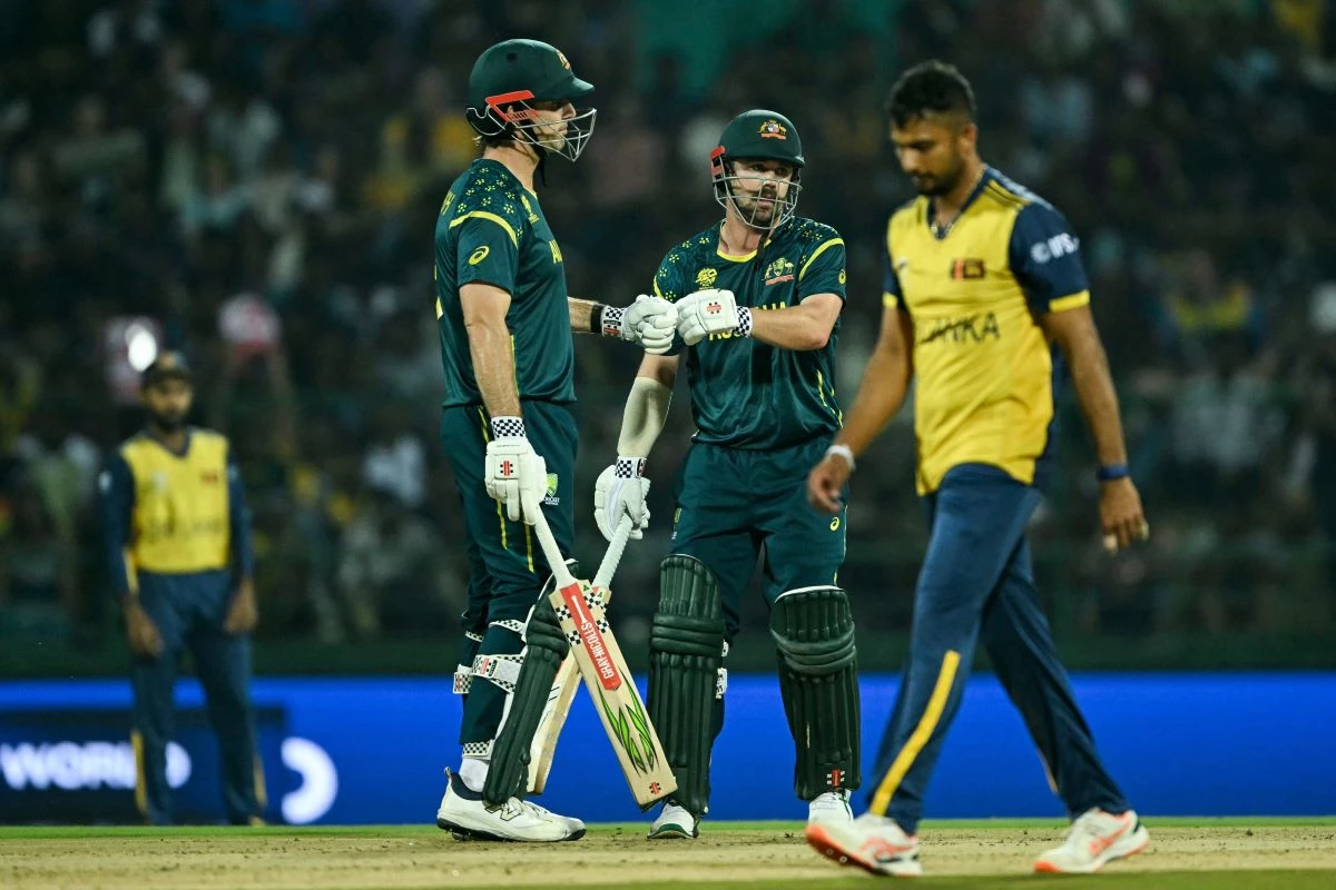 australia s captain mitchell marsh l and travis head c bump their fists during the 2026 icc men s t20 cricket world cup group stage match between australia and sri lanka at pallekele international cricket stadium in kandy on february 16 2026 photo afp