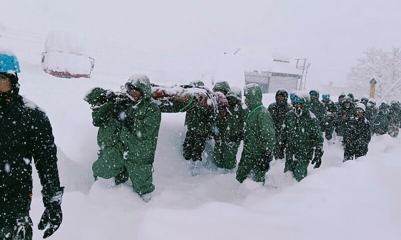 in this handout photo taken and released by the state disaster response force on february 28 rescuers carry border roads organisation workers after an avalanche near mana village in uttarakhand s chamoli district photo afp