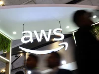 people walk past the logo of amazon web services aws at its exhibitor stall at the india mobile congress 2025 at yashobhoomi a convention and expo center in new delhi india october 8 2025 photo reuters