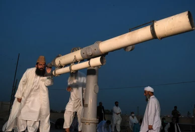 ruet e hilal committee chairperson maulana muhammad abdul khabeer azad looks through telescope for the new moon photo afp