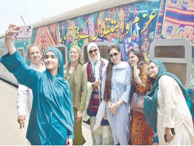 passengers capture moments with the special azadi train beautifully adorned with national flags banners and illustrations depicting the history of the pakistan movement the train part of the 78th independence day and marka e haq celebrations is journeying from karachi to khokhrapar spreading patriotic spirit across the rails photo app