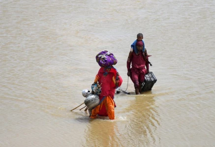 a family with their belongings wade through rain waters following rains and floods during the monsoon season in jamshoro pakistan august 26 2022 photo reuters a family with their belongings wade through rain waters following rains and floods during the monsoon season in jamshoro pakistan august 26 2022 photo reuters