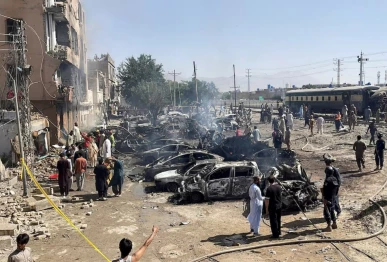people and police officers gather after a blast near a railway track in quetta pakistan may 24 2026 picture taken with a mobile phone reuters stringer