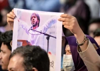 an activist holds a poster of sharif osman hadi senior leader of the student protest group inqilab mancha in dhaka bangladesh photo afp