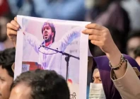 an activist holds a poster of sharif osman hadi senior leader of the student protest group inqilab mancha who was shot outside a mosque during a demonstration to condemn the attack in dhaka on december 15 2025 photo afp