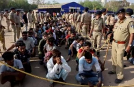 police officers stand next to men they believe to be undocumented bangladeshi nationals after they were detained during raids in ahmedabad india on april 26 2025 file reuters