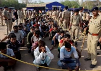 police officers stand next to men they believe to be undocumented bangladeshi nationals after they were detained during raids in ahmedabad india on april 26 2025 file reuters