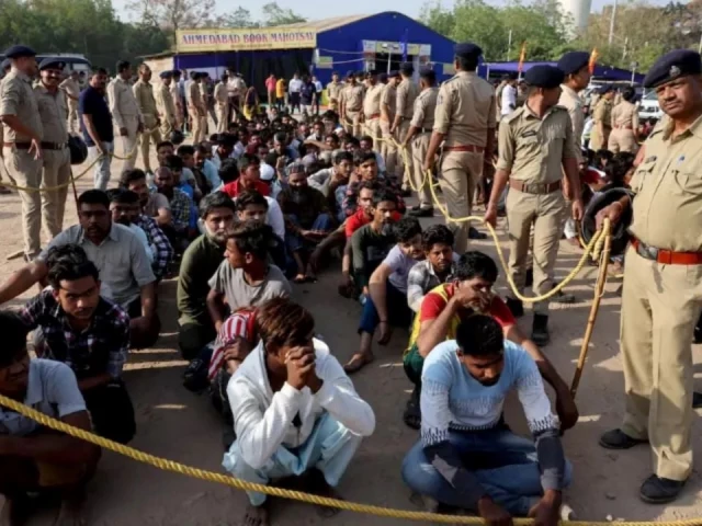 police officers stand next to men they believe to be undocumented bangladeshi nationals after they were detained during raids in ahmedabad india on april 26 2025 file reuters police officers stand next to men they believe to be undocumented bangladeshi nationals after they were detained during raids in ahmedabad india on april 26 2025 file reuters