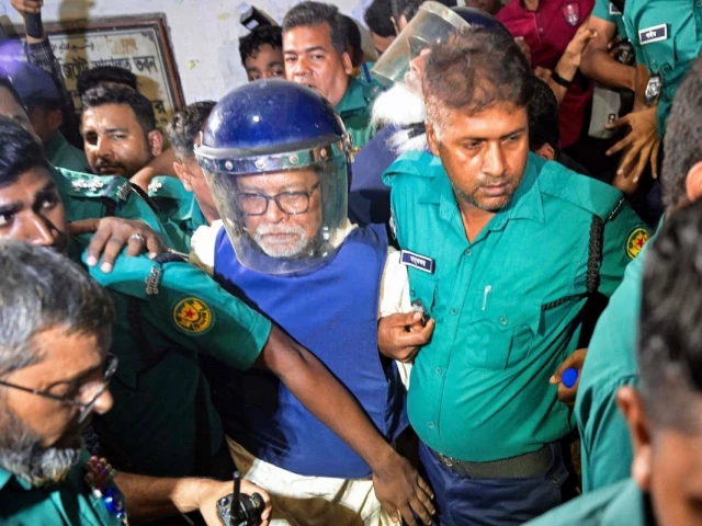 police personnel escort km nurul huda c bangladesh s former chief election commissioner to a court in dhaka on june 23 2025 a day after he was detained on charges of manipulating elections photo afp police personnel escort km nurul huda c bangladesh s former chief election commissioner to a court in dhaka on june 23 2025 a day after he was detained on charges of manipulating elections photo afp