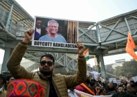 a demonstrator shows a poster of muhammad yunus chief adviser of bangladesh s interim government reading boycott bangladesh during a protest near the bangladesh high commission in new delhi on december 23 2025 to condemn the killing of hindu garment worker dipu chandra das photo afp