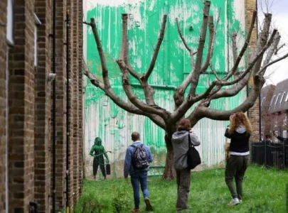 banksy mural in london covered in plastic after vandalism