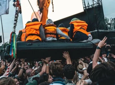 banksy stages controversial refugee boat stunt at glastonbury