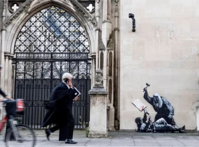 banksy mural outside royal courts of justice shows judge attacking protester before officials cover artwork