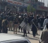 police officers with batons stand near protesters demonstrating a day after the imposition of emergency and governor s rule in khyber pakhtunkhwa in bara october 12 2026 photo reuters