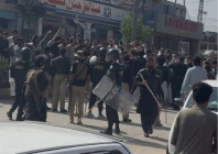 police officers with batons stand near protesters demonstrating a day after the imposition of emergency and governor s rule in khyber pakhtunkhwa in bara october 12 2026 photo reuters
