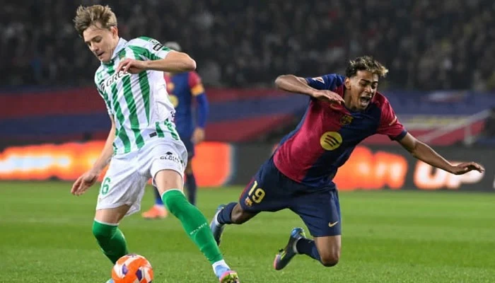 real betis spanish forward jesus rodriguez controls the ball past barcelona s spanish forward lamine yamal during the spanish league football match between fc barcelona and real betis at the estadi olimpic lluis companys in barcelona on april 5 2025 phtoto afp