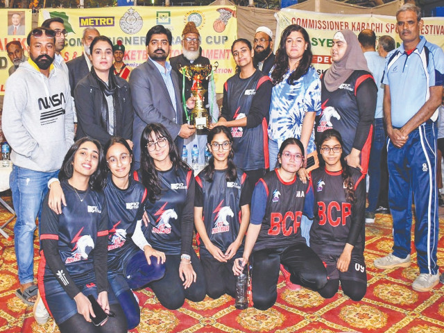 additional commissioner karachi syed ghazanfar ali shah presents the winner s trophy to girls basketball team bcp pechs s captain and its players also seen in the picture are saf games gold medalist naseem hameed hammad haider ghulam mohammad khan asif gulfam asghar baloch and amir shareef photo app