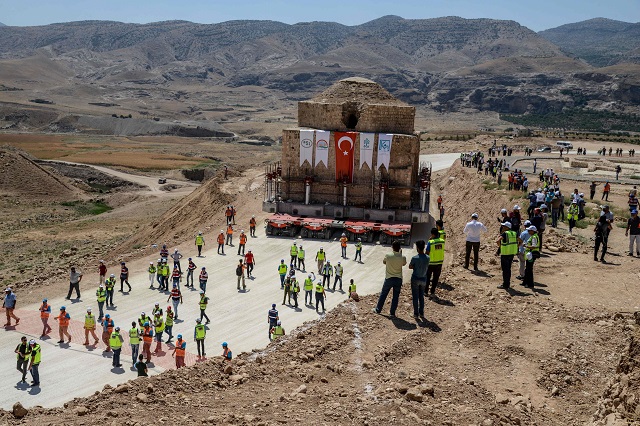 People gather as the Artuklu Hamam, a centuries-old bath house weighing 1,600 tonnes, is loaded onto a wheeled platform an moved down a specially constructed road, on August 6, 2018. PHOTO: AFP