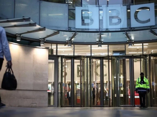 a man walks towards bbc building entrance photo afp