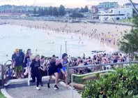 a screengrab from a user generated video shows beachgoers fleeing sydney s bondi beach after gunmen opened fire photo afp