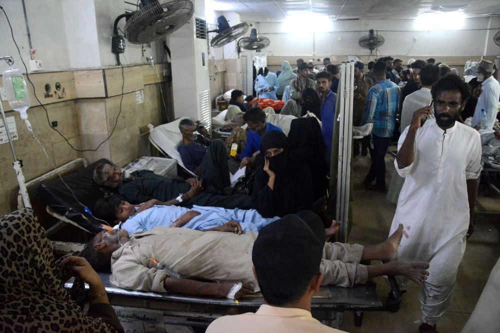 Multiple patients on a bed at Dr Ruth Pfau Civil Hospital's Emergency Ward. Photo File: EXPRESS