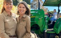 terri irwin shares adorable photos of daughter bindi and granddaughter grace as babies on a tractor