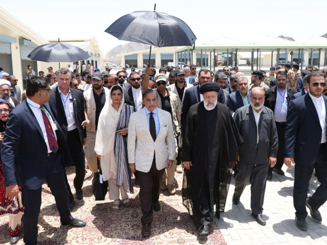 pm shehbaz sharif and iranian president ebrahim raisi visit a common market during the inauguration of the mand pish photo reuters