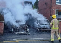 a firefighter works to extinguish a fire in three cars parked on the street at tigers bay during a protest after a knife attack on june 8 left a man seriously injured and prompted police to declare a critical incident in belfast northern ireland on june 9 2026 photo reuters
