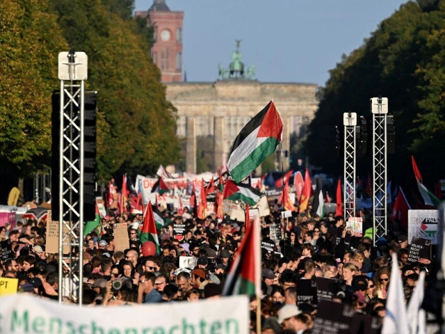 protesters march at a together for gaza demonstration near the brandenburg gate in berlin on september 27 2025 photo afp