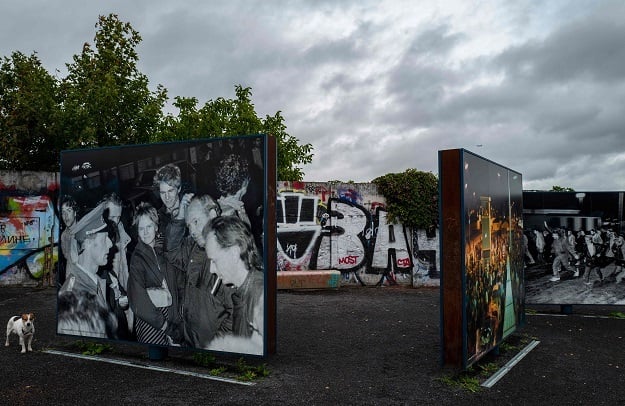 Large photographs showing east Germans crossing into west Berlin through the Bornholmer Strasse/Boesebruecke checkpoint, the first border crossing to be opened during the fall of the Berlin Wall on the evening of November 9, 1989, are on permanent display as part of a memorial near the bridge (Photo: AFP)