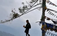 a boy in a traditional costume walks past prayer flags in thimphu bhutan on april 16 2016 photo reuters