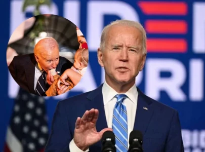 joe biden accidentally bites baby s arm and a child s foot at white house halloween event