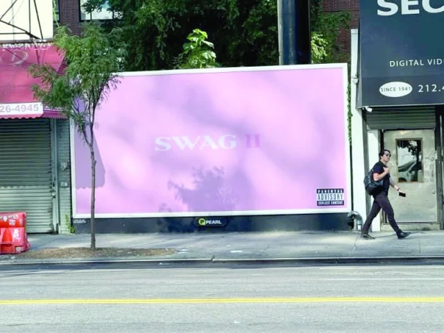 people walk by a billboard to promote justin bieber s new album swag ii photo instagram lilbieber people walk by a billboard to promote justin bieber s new album swag ii photo instagram lilbieber
