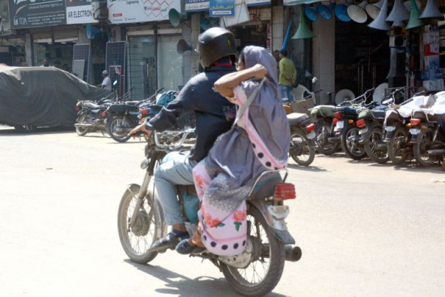 waiting for calamity a woman rides on a motorcycle unaware of her dress hanging close to chain of the bike which can cause a fatal accident photo jalal qureshi express waiting for calamity a woman rides on a motorcycle unaware of her dress hanging close to chain of the bike which can cause a fatal accident photo jalal qureshi express