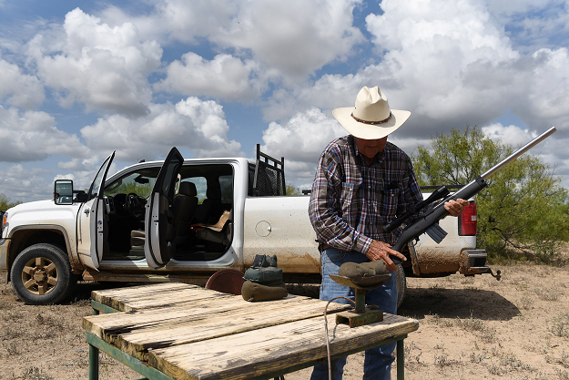 Bill Martin, 72, prepares to shoot a Ruger Mini-14 rifle on his ranch near Carizzo Springs, Texas. PHOTO: REUTERS