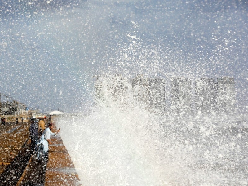 1 3 a man with a mobile phone takes a picture of rising waves before the arrival of the cyclonic storm biparjoy over the arabian sea in karachi pakistan june 14 2023 photo reuters