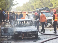 police and rescue officials stand at the site of a blast outside a court building in islamabad photo reuters