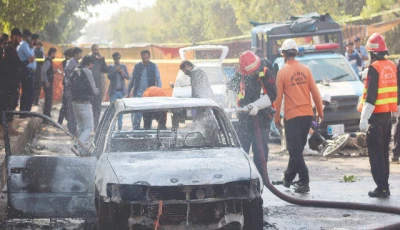 police and rescue officials stand at the site of a blast outside a court building in islamabad photo reuters