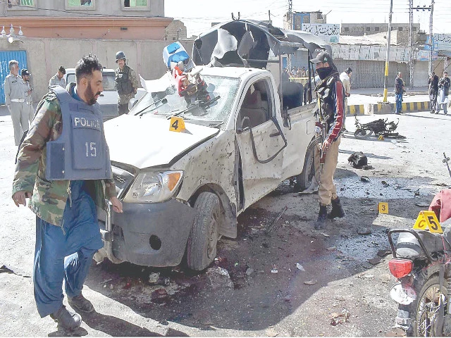 security personnel inspect the site of an explosion in quetta photo inp