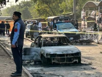 policemen examine damaged vehicles after a suicide blast outside the district court in islamabad on november 11 2025 photo afp
