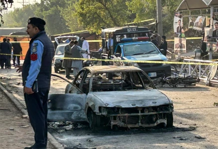 policemen examine damaged vehicles after a suicide blast outside the district court in islamabad on november 11 2025 photo afp