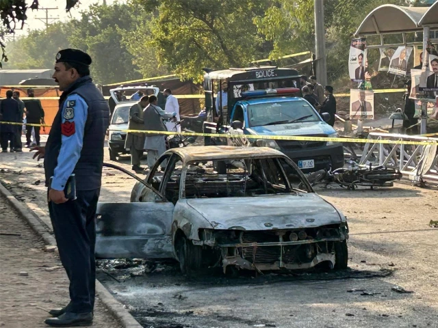 policemen examine damaged vehicles after a suicide blast outside the district court in islamabad on november 11 2025 photo afp policemen examine damaged vehicles after a suicide blast outside the district court in islamabad on november 11 2025 photo afp