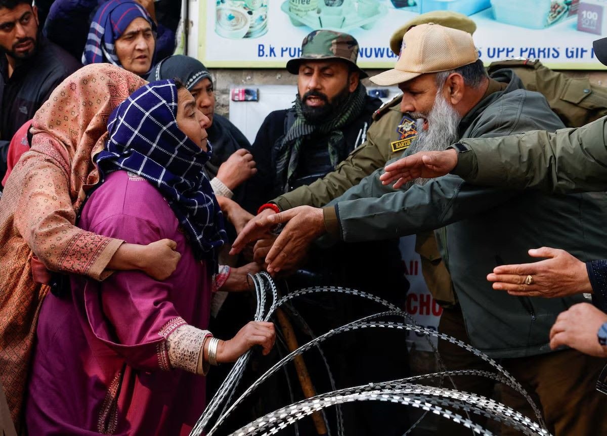 A woman urges Indian security personnel to release the body of her brother, Muhammad Shafi Parry, who was killed in an explosion at a police station in Srinagar, Indian Kashmir, November 15, 2025. PHOTO: REUTERS