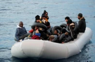 migrants are seen on a dinghy following a failed attempt to cross to the greek island of lesbos as a turkish coast guard boat aproaches them on the waters of the north aegean sea off the shores of canakkale turkey march 6 2020 photo reuters